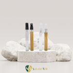 شیشه عطر ویال 10 میل با کپ و والف شفاف و مشکی کد LG06B برروی سنگ